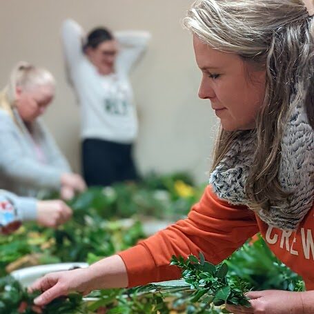 Image of lady working on a wreath